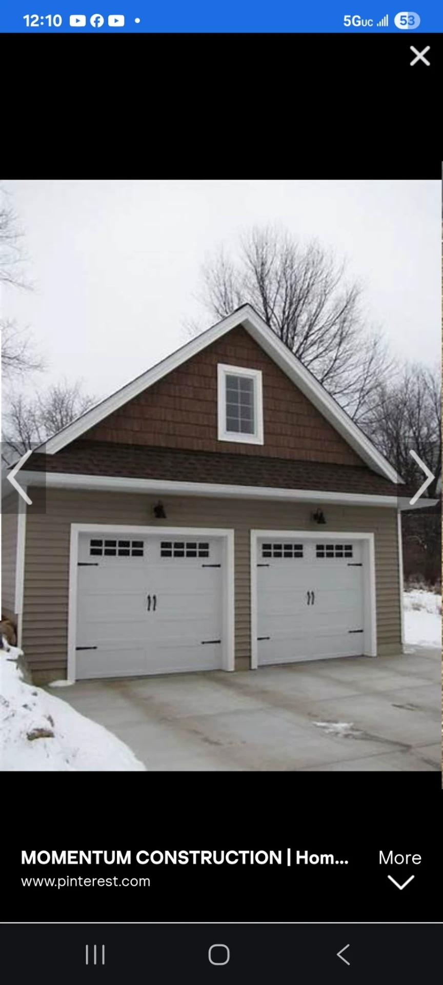 Detached two-car garage with white carriage-house doors